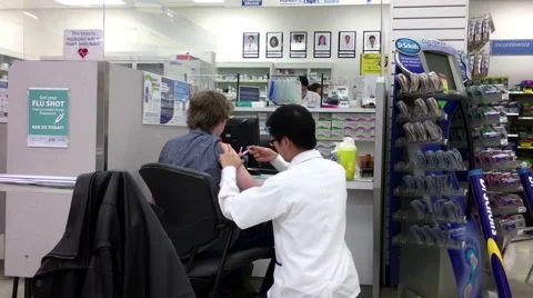 Motion of young man having flu shot at pharmacy section Stock Footage 69042392