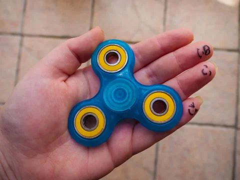 Motionless Fidget Spinner in Hand Stock Photos