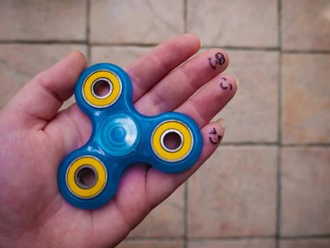 Motionless Fidget Spinner in Hand Stock Photos