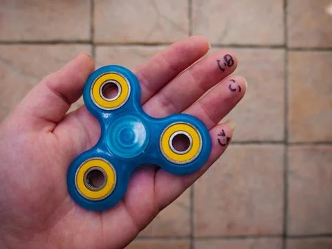 Motionless Fidget Spinner in Hand Stock Photos