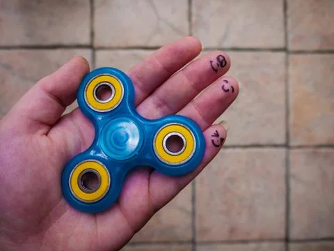 Motionless Fidget Spinner in Hand Stock Photos