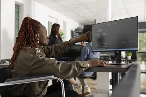 Motivated black female programmer working at modern desk Stock-Fotos