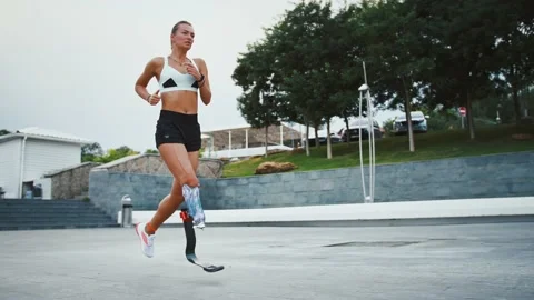 Motivated disabled runner training outdoors, slow motion Stock Footage 137793908