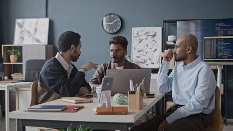 Motivated Diverse Male Programmers Brainstorming on Software Project in Office Stock-Footage 337475726