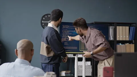 Motivated Multiethnic IT Team Analyzing Code on Screen during Office Meeting Stock Footage 337482143