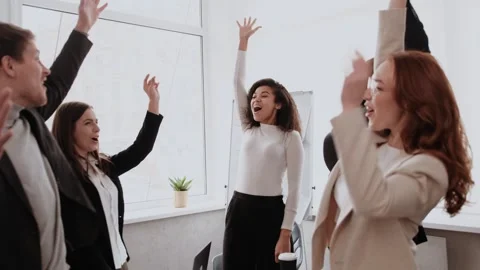 Motivated multinational team raise high fives on briefing after finding problem Stock Footage 264578249