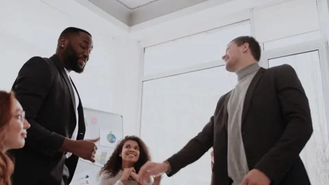 Motivated multinational team raise high fives on briefing after finding problem Stock Footage 264578278