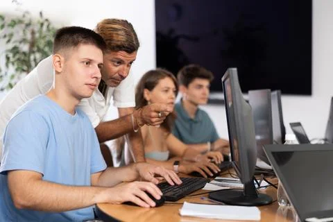 Motivated young trainee developer working at IT startup with mentor Stock Photos