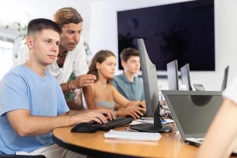 Motivated young trainee developer working at IT startup with mentor Stock Photos