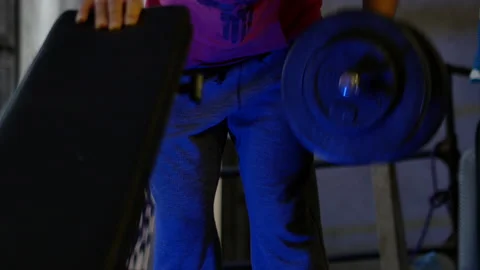 Motivation shot of man half down body doing "one hand rowing" musculation Stock Footage 142121689
