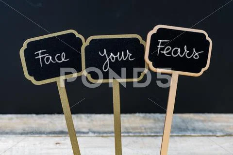 Motivational message Face Your Fears written with chalk Stock Photos