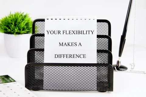 A motivational note about flexibility sits in a black mesh organizer on a d.. Fotos de archivo