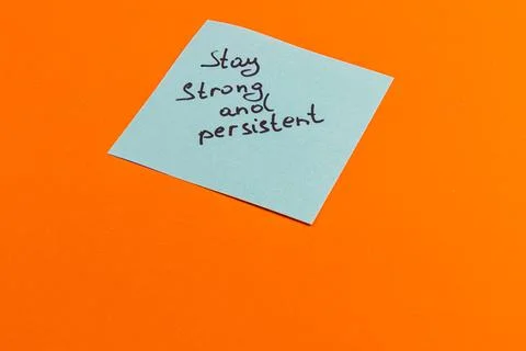 Motivational note emphasizing strength and persistence on vibrant background Stock Photos