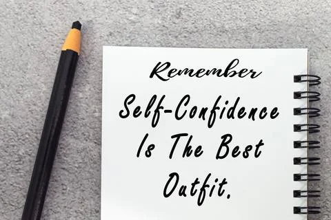Motivational quote on notepad - Remember self confidence is the best outfit. Stock Photos