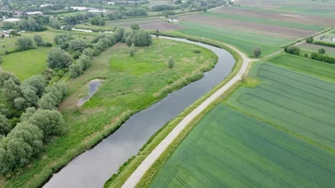 The Motława River flows smoothly between green fields. Stock Footage 156132213