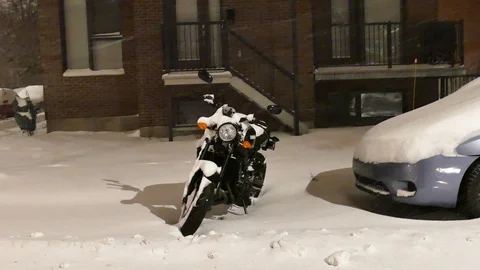 Moto during snowstorm Stock Footage 125548874