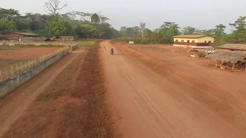 Moto follow on red road Stock Footage 81067853