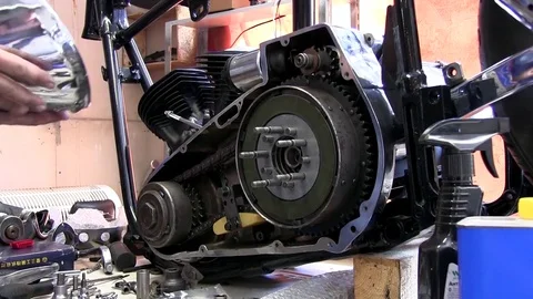 Moto mechanic assembling motorcycle in garage Stock Footage 81480778