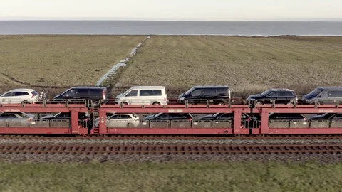 Moto Rail Train Carrying Vehicles and Passengers on a Journey Stock Footage 117896331