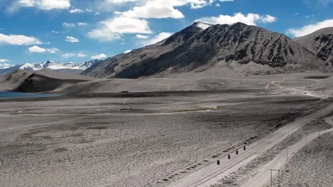 MotoBikers In Formation Journey Over Empty Highland Landscape With Mountain Stock-Footage 339342402
