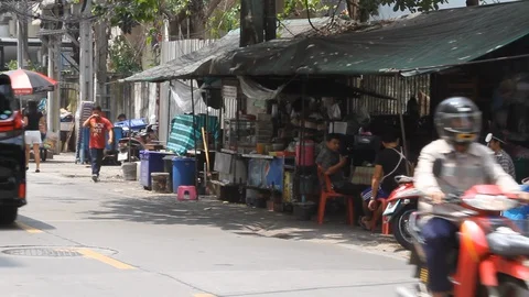 Motor bikes streak down the back Streets of Bangkok Stock Footage 129810049