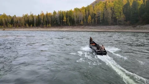 A motor boat breaks the waves of a stormy river Stock Footage 147241453