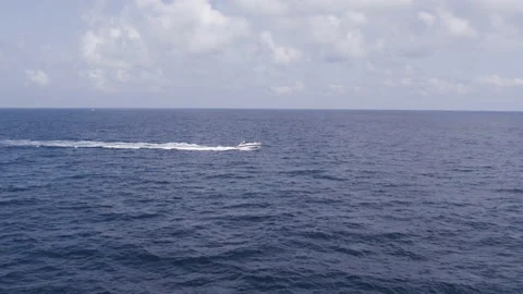 Motor boat cuts the waves of the ocean. Drone top view Endless ocean and sky. Stock Footage 166135352