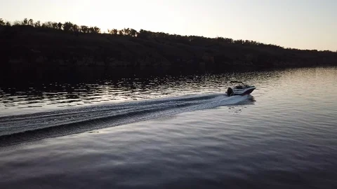 Motor boat floating on the river at sunset Stock Footage 119638691