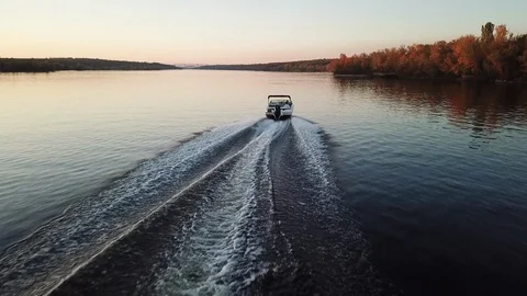 Motor boat floating on the river at sunset Stock Footage 119638888