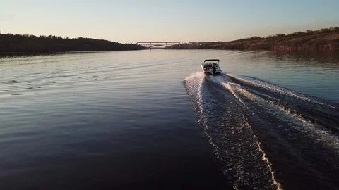 Motor boat floating on the river at sunset Stock Footage 119639326