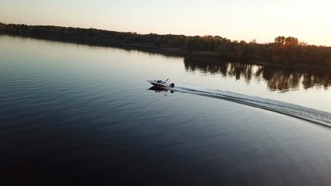 Motor boat floating on the river at sunset Stock Footage 119639495