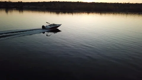 Motor boat floating on the river at sunset Stock Footage 119639976