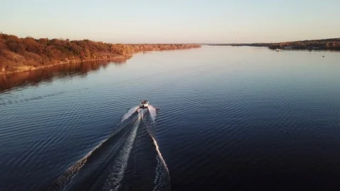 Motor boat floating on the river at sunset Stock Footage 119640156