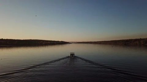 Motor boat floating on the river at sunset Stock Footage 119640333