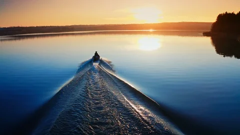 Motor boat floating on the river at sunset. Path on water after motion of motor  Video stock 123523339