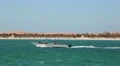 Motor boat floats near the Lulu island in Abu Dhabi, United Arab Emirates HD Footage