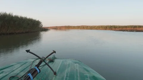 Motor boat is moving forward on river. Anchor is on boats nose. Stock Footage 124123039