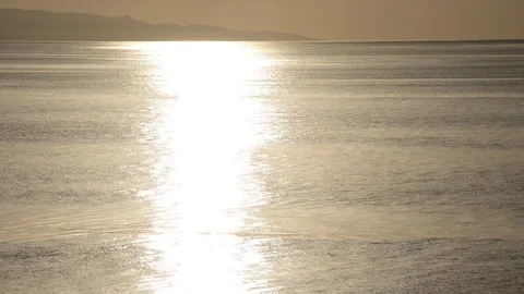 Motor boat passes by two men on the shining sea Stock Footage 82969999