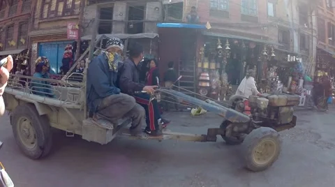 Motor kart going through Katmandu market place Stock Footage 65773514
