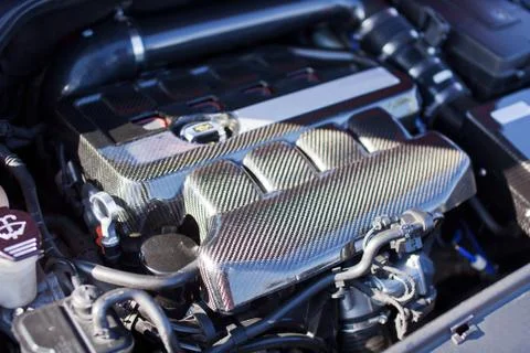 Motor made of carbon elements close up on a sports car Stock Photos