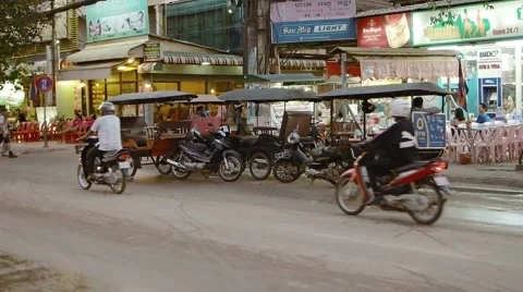 Motor rickshaws parked curbside, awaiting passengers. Siem Reap. FullHD video Видео 60746490
