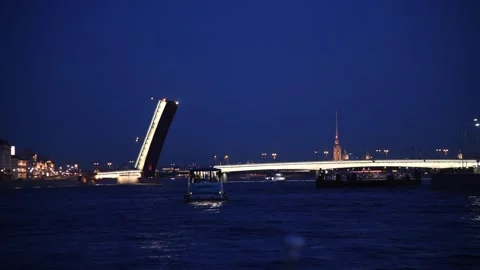 Motor ship sails by open bascule bridge at night Stock Footage 248713105