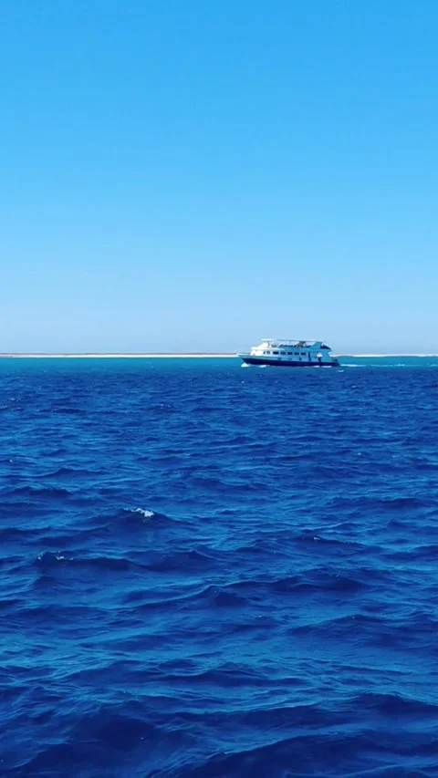 Motor yacht sailing in deep blue ocean water near island coast Hurghada Egypt Stock Footage 341363022