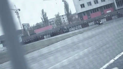 Motoracers taking a sharp corner behind the fence view Stock-Footage 70319954