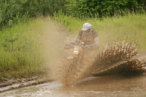 Motorbike drives through water and mud at rallye berlin-breslau Stock Photos