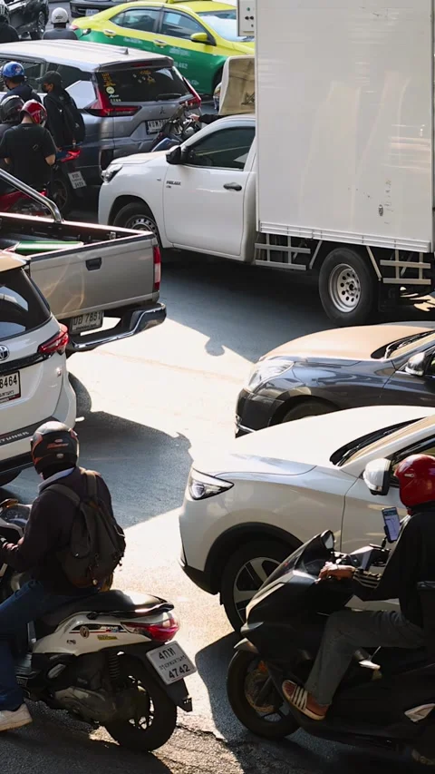 Motorbike Riders Weaving Through Congested Bangkok City Traffic Stock Footage 324883548