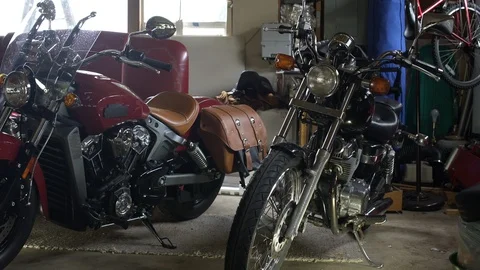 Motorbikes parked in garage, side by side, panning left. 動画素材 88029929
