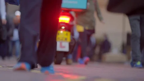 Motorbikes pass through anonymous crowd - Low angle Stock Footage 70550793