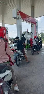 Motorbikes Queue Up For Fuel Stock Photos