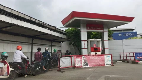 Motorbikes Queueing for Subsidized Fuel in Jakarta Gas Station Stock Footage 198968167